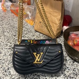 Black Louis Vuitton bag with gold hardware and removable handle